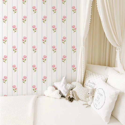 a cozy and inviting bedroom scene, featuring a bed with white linens and a canopy, a wallpapered wall with a repeating pattern of pink flowers, and a collection of stuffed animals and decorative pillows on the bed.