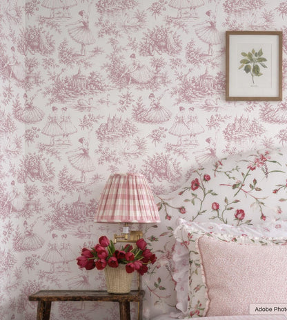 a bedroom with a pink and white floral wallpaper, a wooden nightstand with a lamp and a vase of red flowers, and a framed picture on the wall.