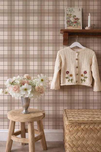a cozy and charming interior with a wooden stool, a vase of flowers, a wooden shelf with a sweater, and a woven basket.