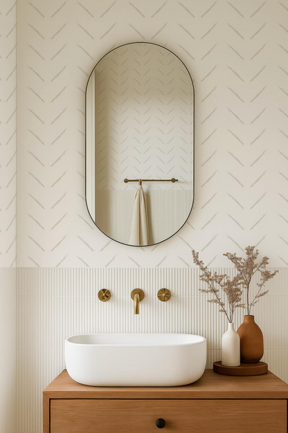 a modern bathroom with a white oval-shaped sink, a mirror above it, and a wooden vanity below. The bathroom has a minimalist and clean design, with a white color scheme and a geometric pattern on the walls.