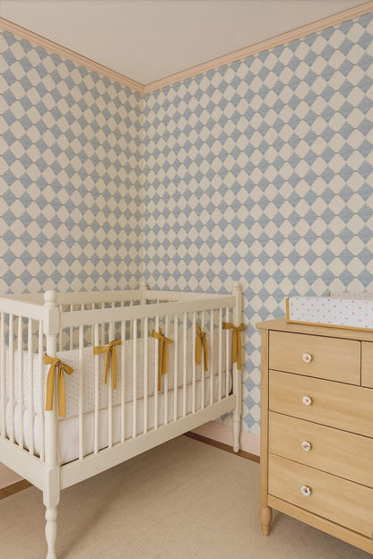 a cozy nursery room with a white crib, a wooden dresser, and a patterned wallpaper.