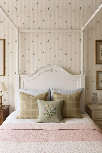 a cozy bedroom with a white four-poster bed, a floral wallpaper, and a pink and white bedspread.