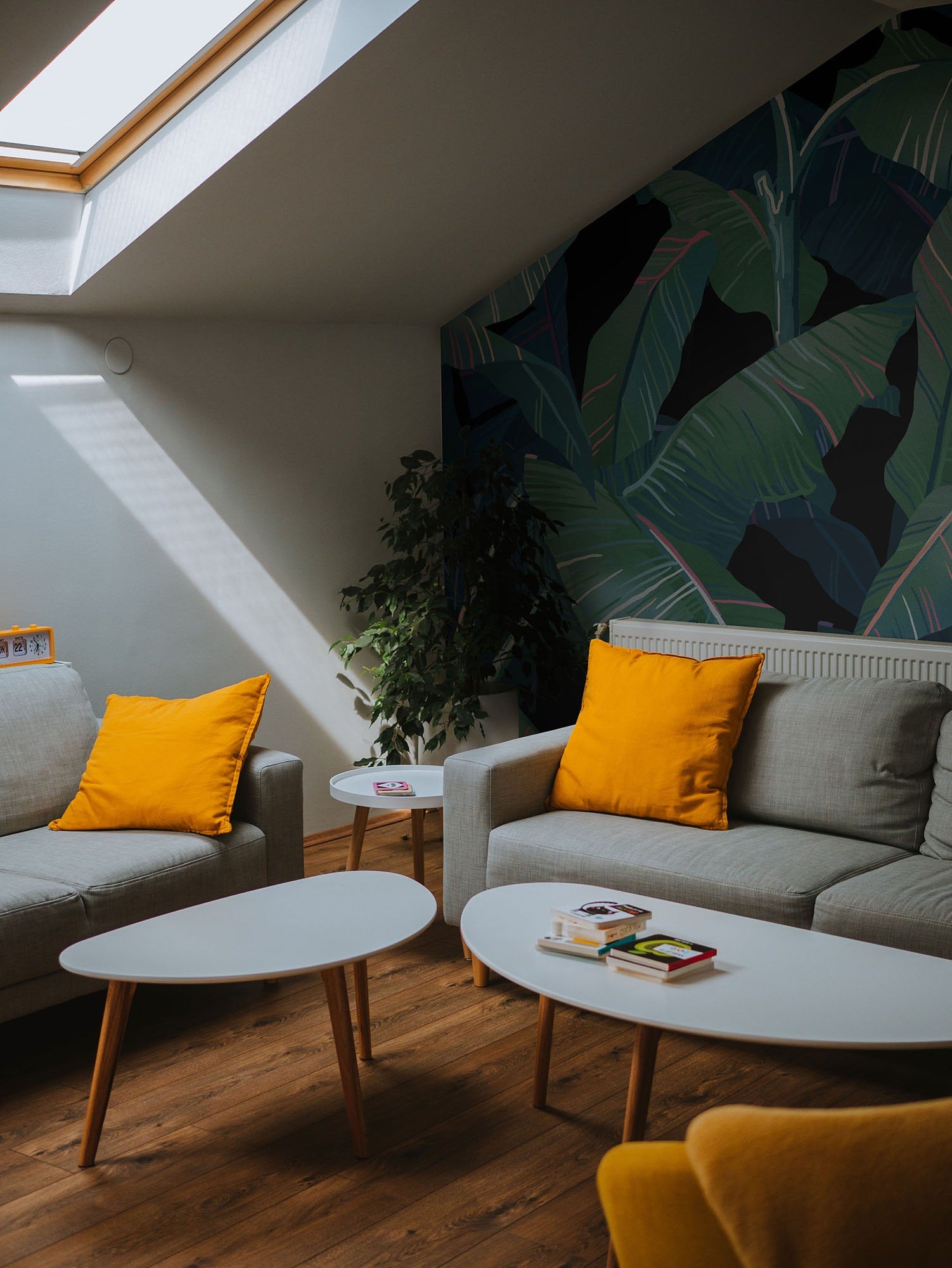 a living room filled with furniture and a skylight