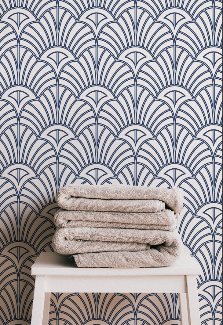 a stack of towels sitting on top of a white stool