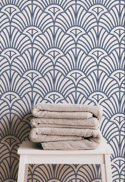 a stack of towels sitting on top of a white stool
