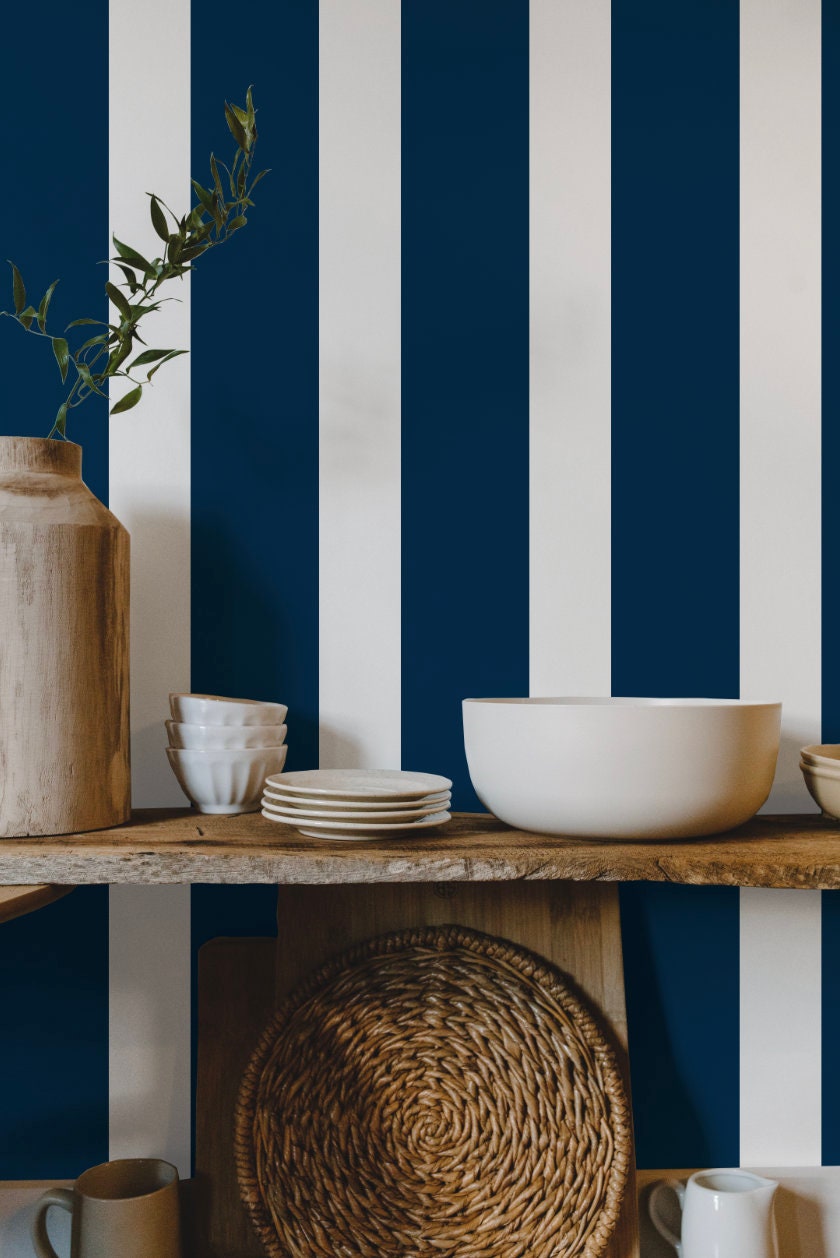 a shelf with plates, bowls and a vase on it