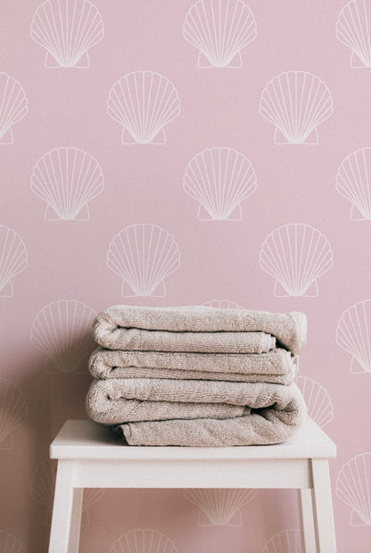 a stack of towels sitting on top of a white stool