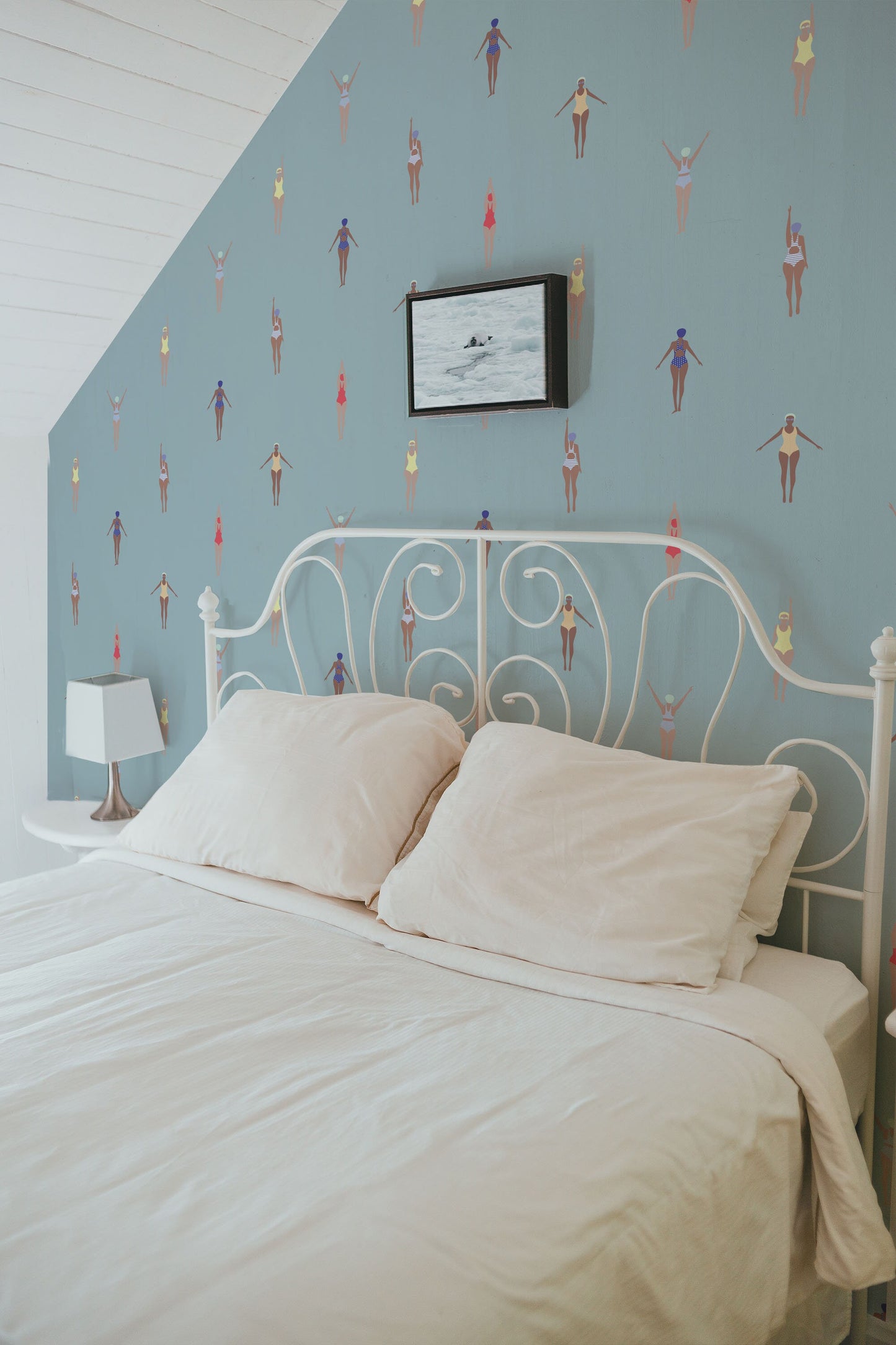 a bed with a white headboard and a white night stand