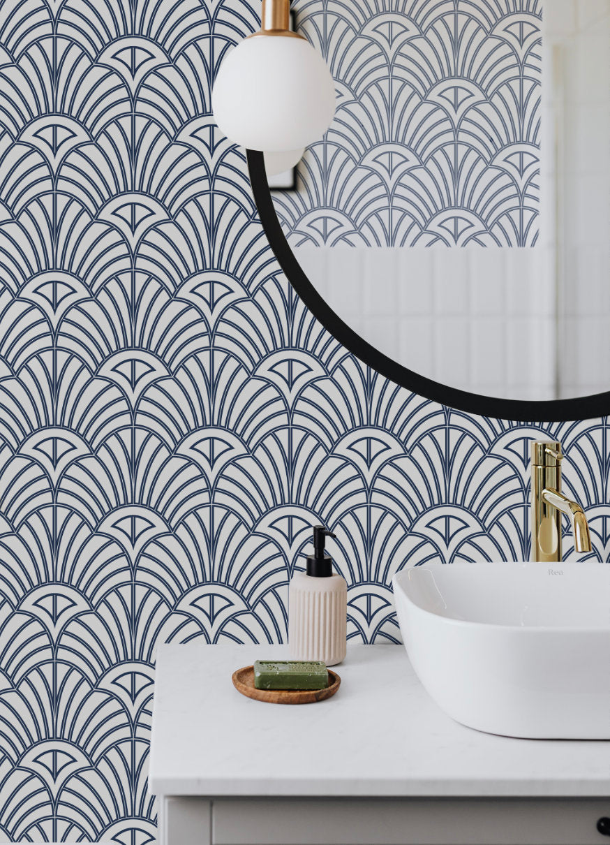 a white sink sitting under a mirror next to a mirror