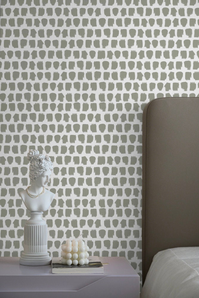 a white bed sitting next to a gray headboard