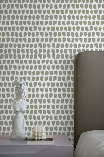 a white bed sitting next to a gray headboard