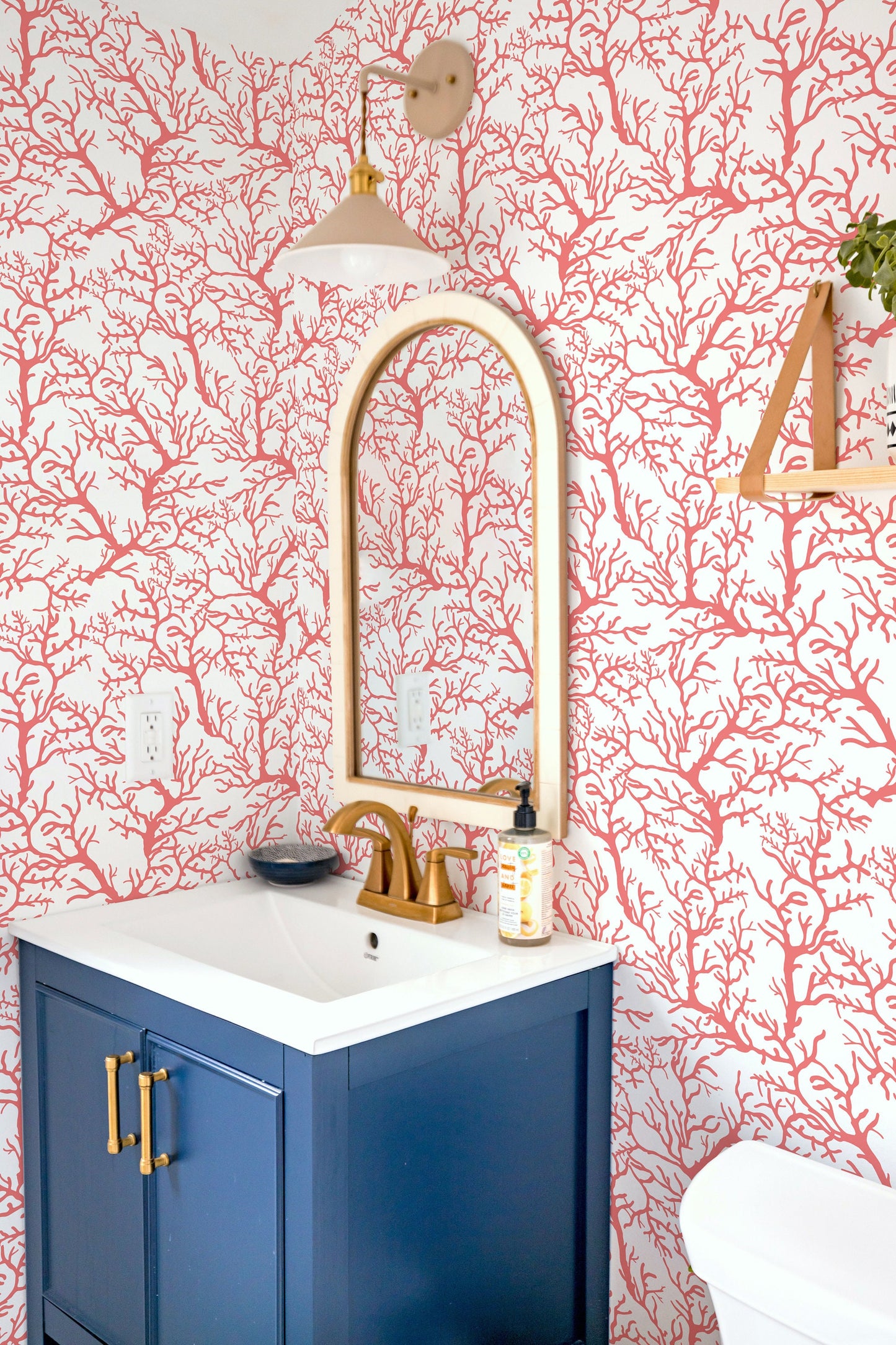 a white toilet sitting next to a bathroom sink