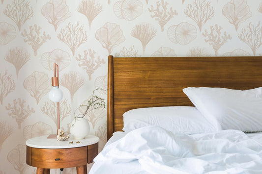 a bed with a white comforter and a wooden headboard