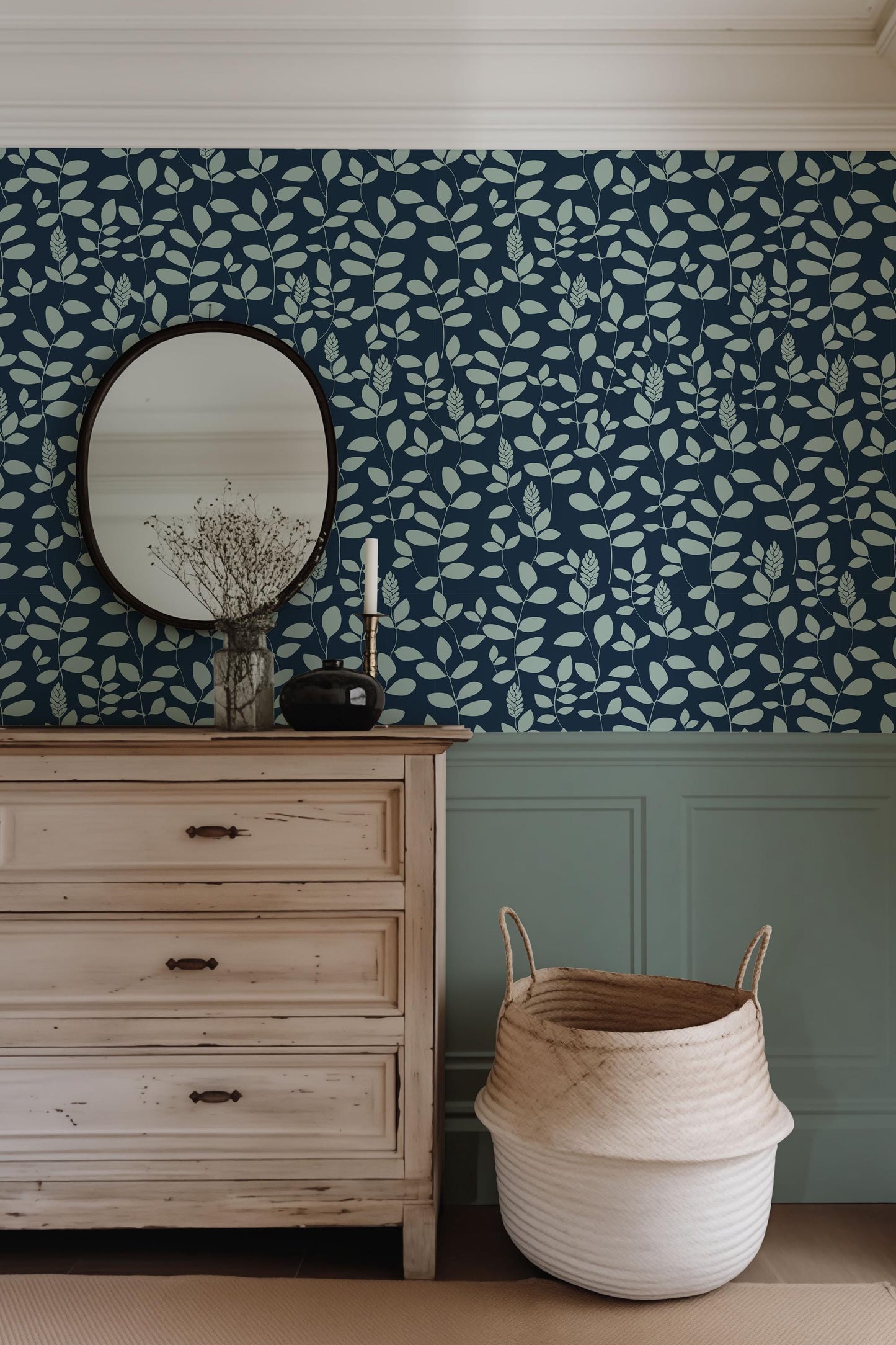 a dresser and mirror in a room with blue wallpaper