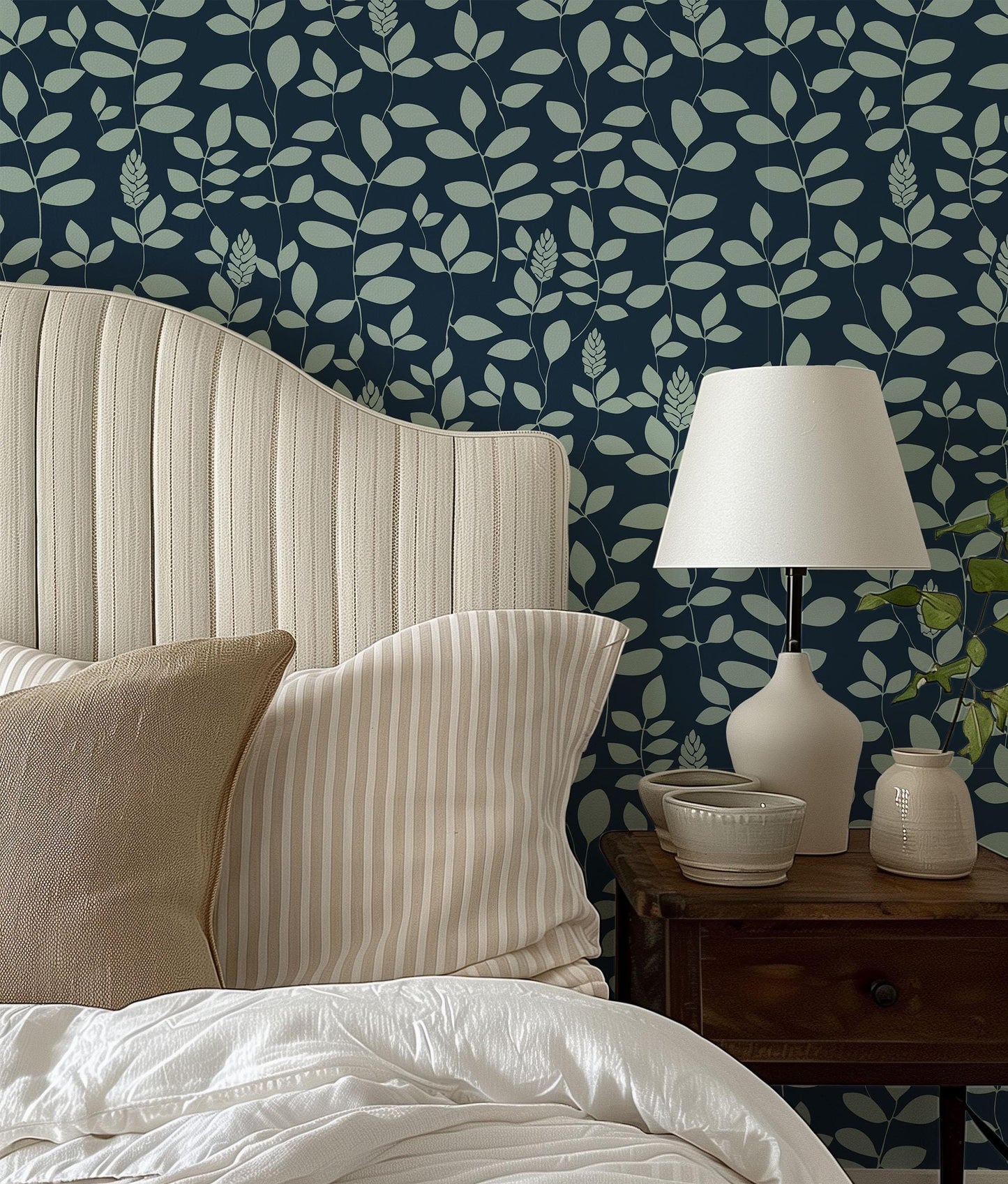 a bed with a white headboard sitting next to a lamp