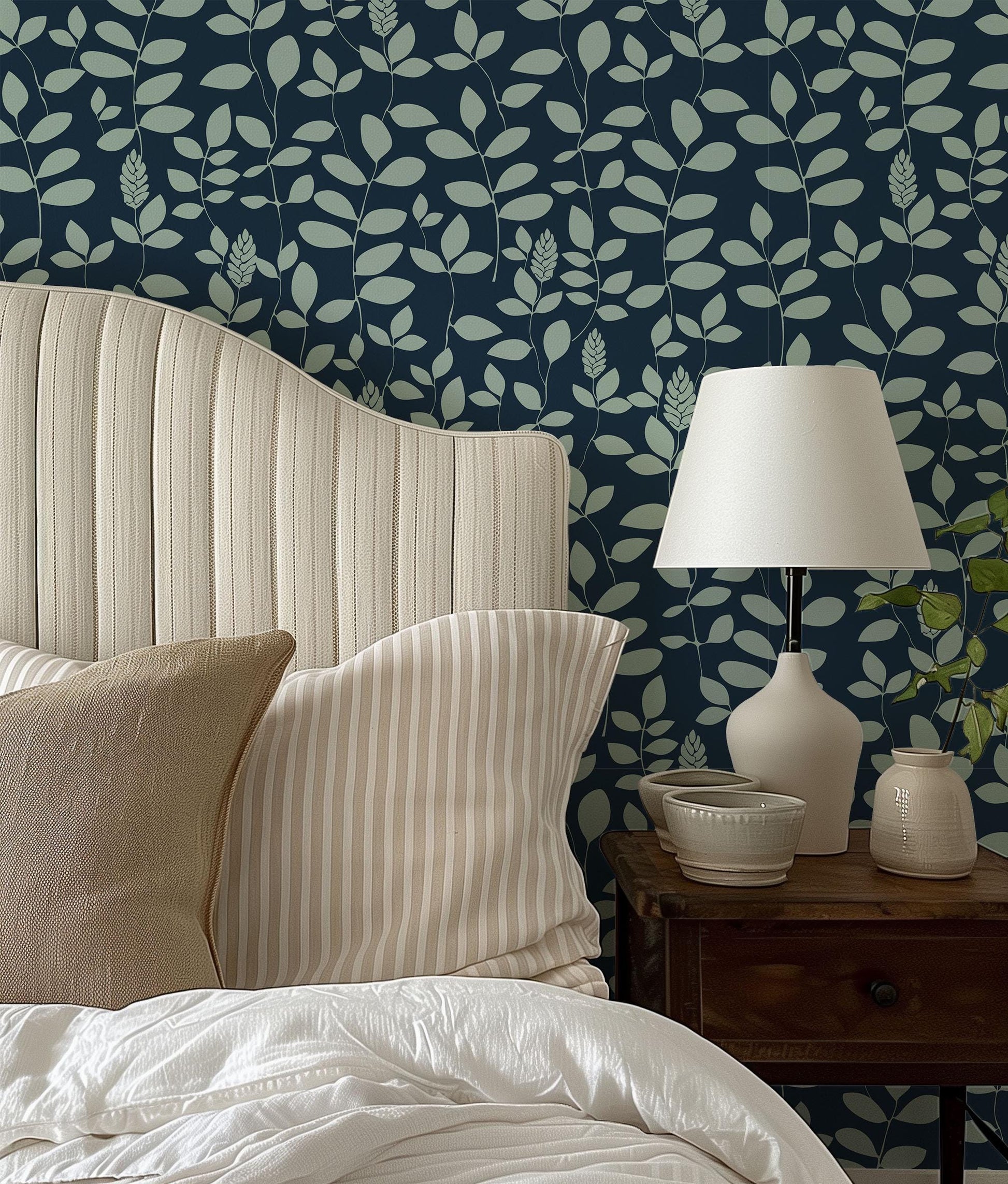a bed with a white headboard sitting next to a lamp