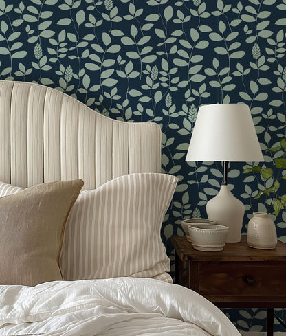 a bed with a white headboard sitting next to a lamp