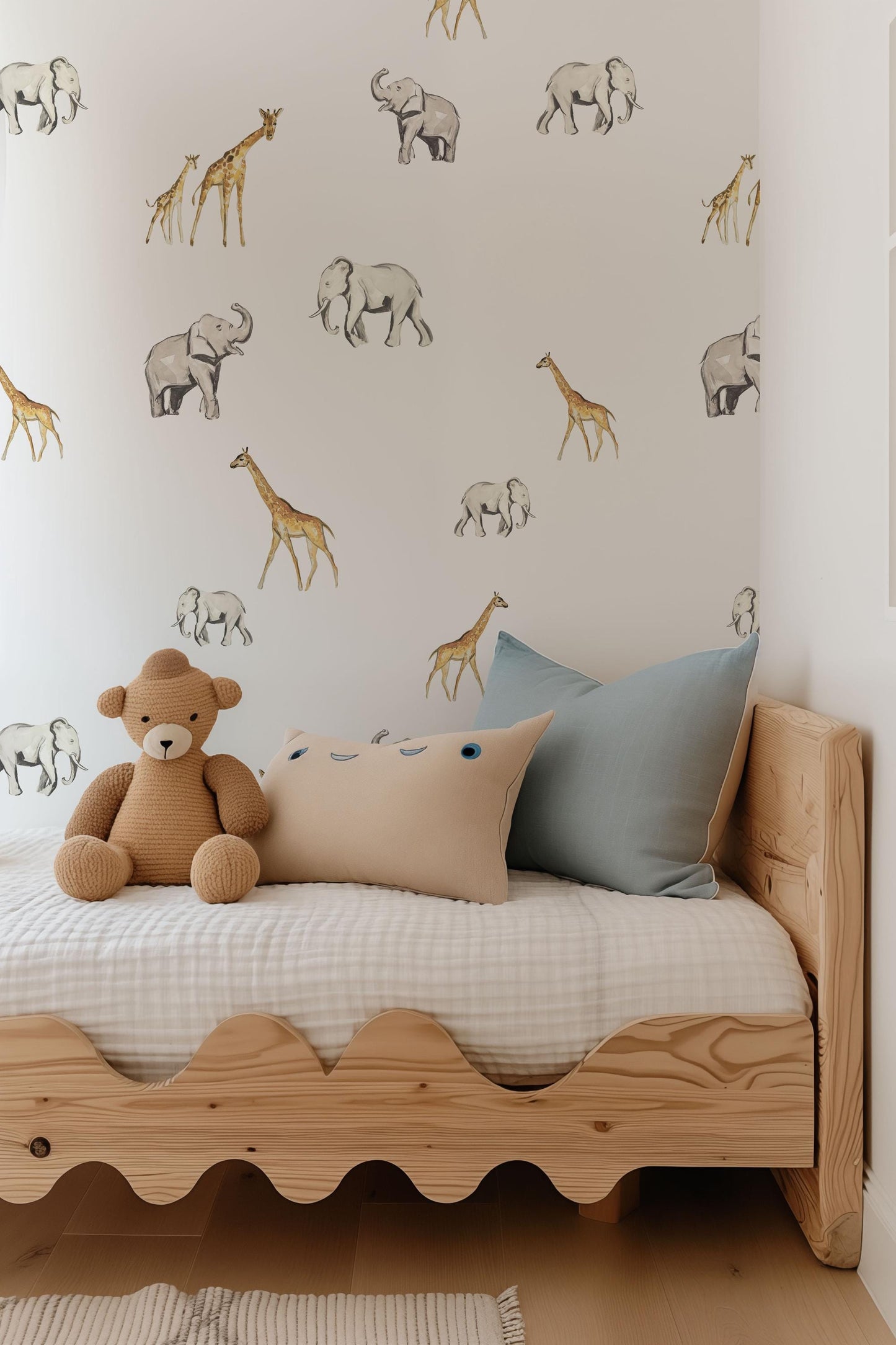 a teddy bear sitting on a bed in a bedroom