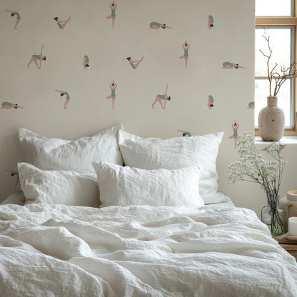 a bed with a white comforter and pillows