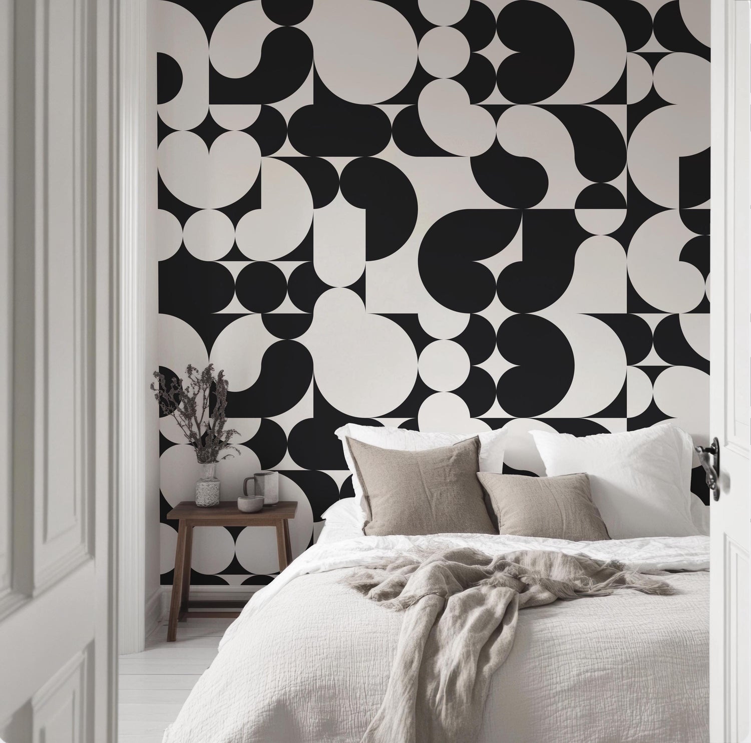 a bedroom with black and white wallpaper and a bed